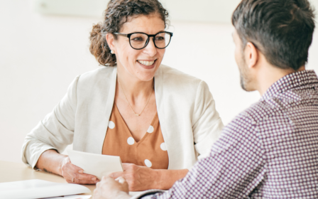 office employee discussing professional development with a colleague