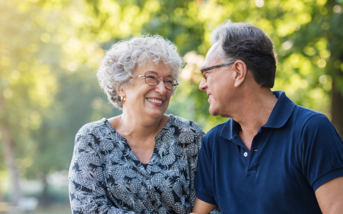 elderly woman smiling discussing our care services with her husband